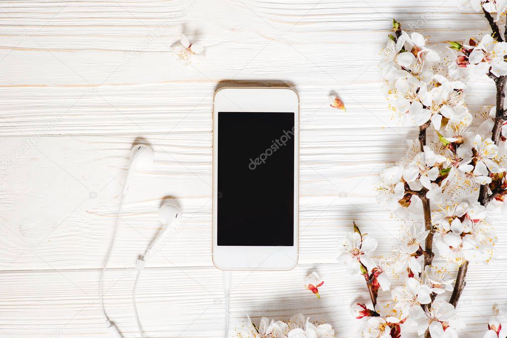White wooden desktop with modern smart phone