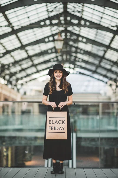 Woman holding Black Friday paper bag — Stock Photo, Image