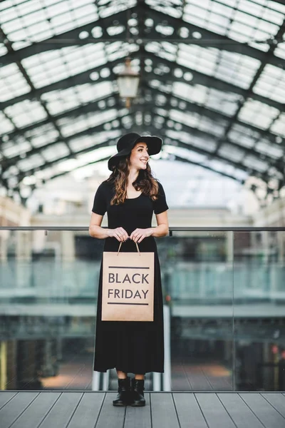 Woman holding Black Friday paper bag — Stock Photo, Image