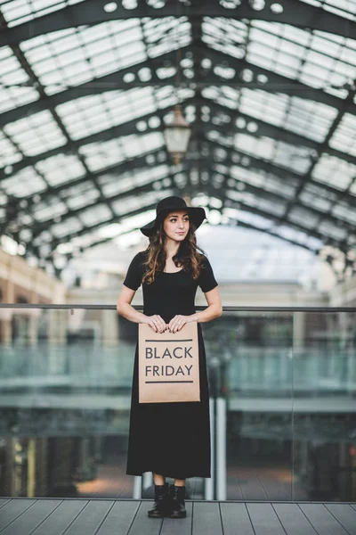 Woman holding Black Friday paper bag — Stock Photo, Image