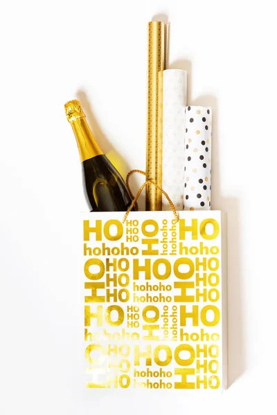 Shopping bag with wrapping paper and bottle of champagne — Stock Photo, Image