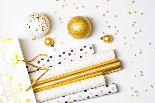 Christmas wrapping paper and golden balls — Stock Photo, Image