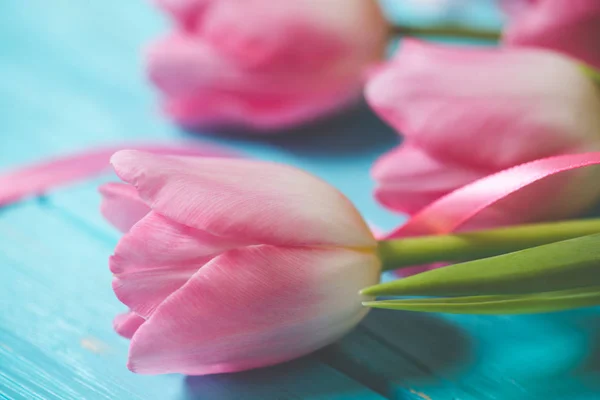 Wooden blue background and pink tulips — Stock Photo, Image