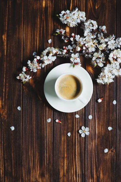 Apricot spring flowers and coffee cup