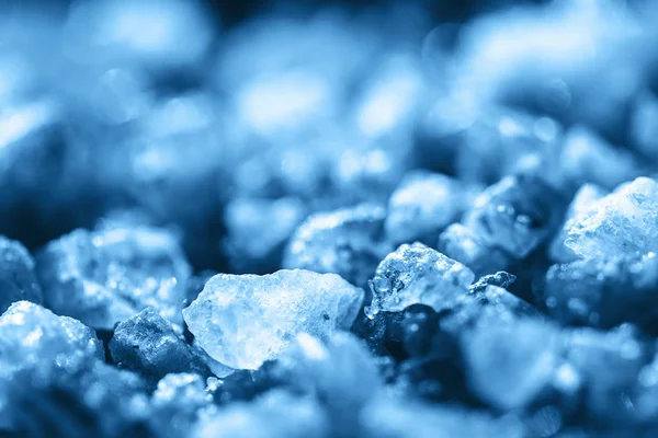 Blue crystals of sea salt close-up background.