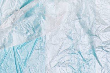 Mavi arkaplanda plastik poşet dokusu.