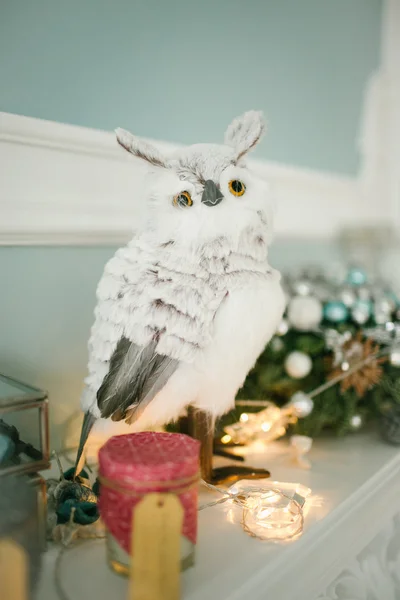 Christmas decorated room with owl on fireplace — Stock Photo, Image