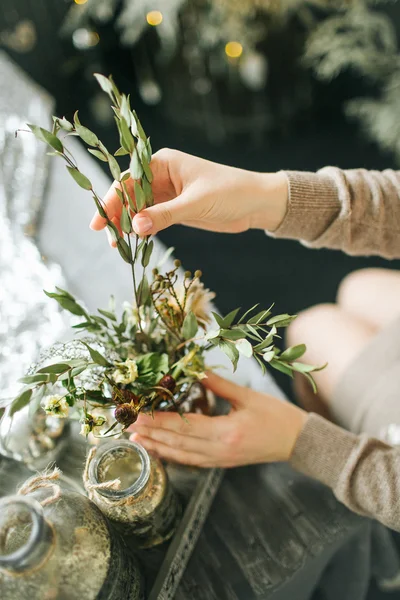 Floristin arbeitet mit Blumenschmuck auf Holztisch — Stockfoto