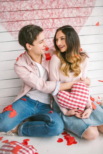 Fiatal pár a szerelem felölelő alapján berendezett studi konfetti — Stock Fotó