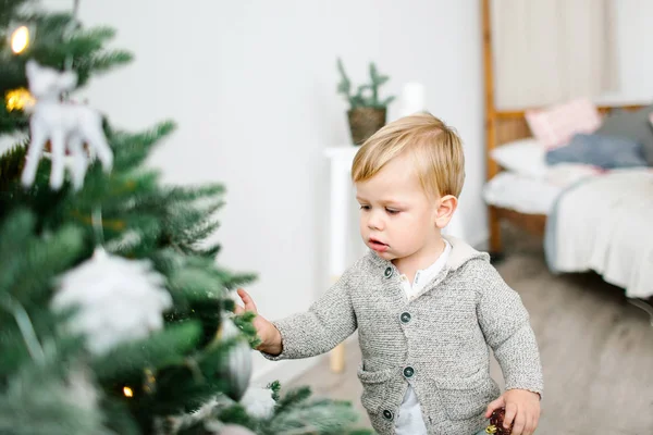 Petit garçon à la recherche de cadeaux à l'arbre de Noël — Photo