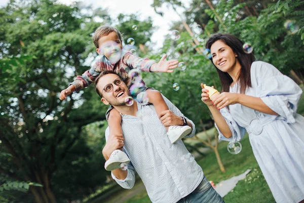 Kabarcık wands Park açık havada oynamaktan mutlu genç aile