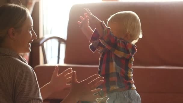 Niño intenta dar los primeros pasos — Vídeo de stock