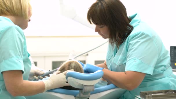 Menina sentada no consultório dos dentistas — Vídeo de Stock