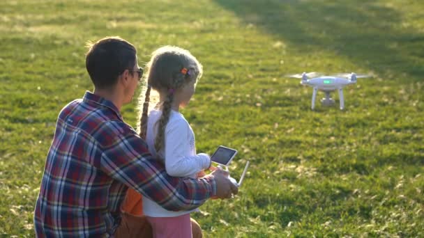 Father shows his daughter how to control drone — Stock Video