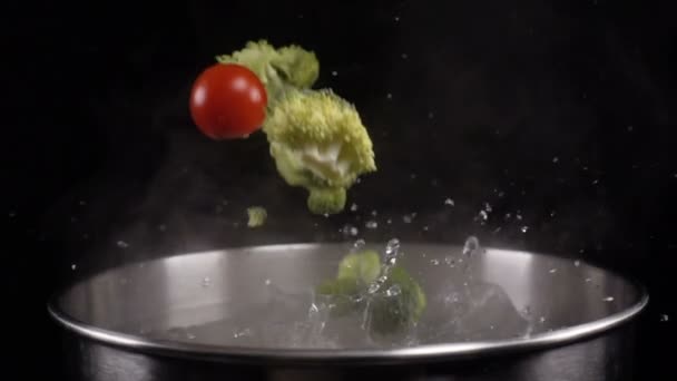 Throwing vegetables into boiled water — Stock Video