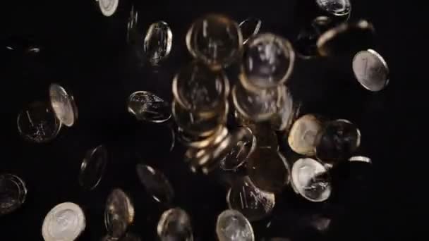 One euro coins fall on a black background — Stock Video