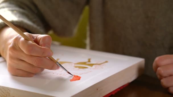 Woman painter paints a religious icon — Stock Video