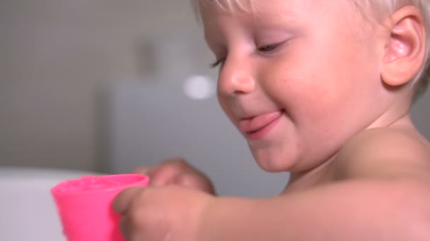 Twee-jarige jongen probeert te zijn mond spoelen na zijn tanden poetsen — Stockvideo