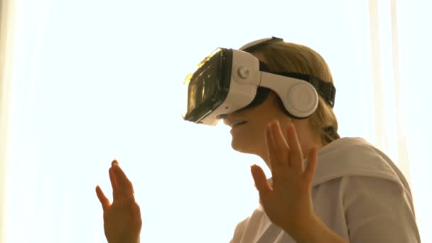 Beautiful young female playing game in vr glasses. — Stock Video