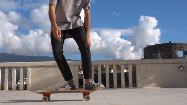 Close up of skateboarder man doing 360 kickflip heelflip flip trick in slow motion jump — стоковое видео