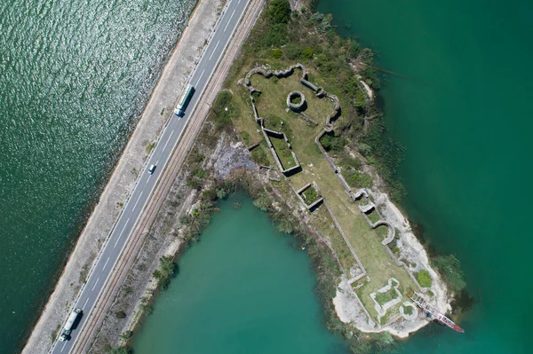 Vista aérea del lago Skadar, presa e isla con antigua fortaleza medieval Lesendro —  Fotos de Stock