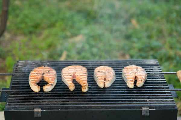 Grilled steaks of salmon on the grill — Stock Photo, Image