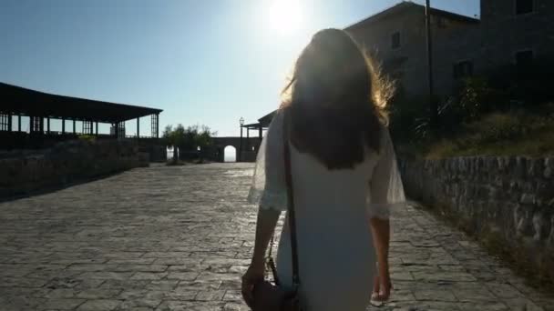 Young woman walks the streets of the old city of Ulcinj — Stock Video