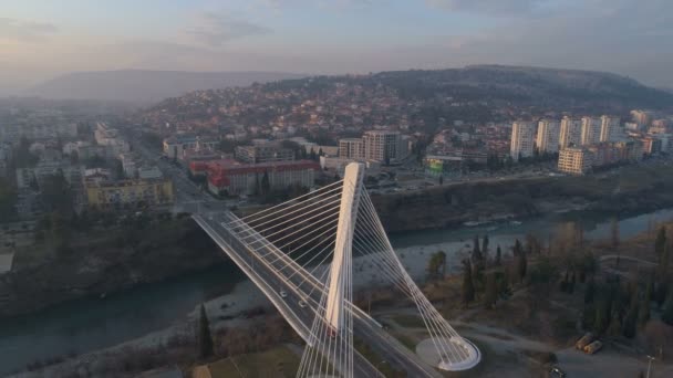 Podgorica, Montenegro - January 13, 2020: aerial view of Millennium bridge over Moraca river — ストック動画