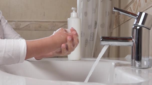 Prevention coronavirus COVID-19 . Handwashing. The child washes his hands with running water and soap. — Stock Video