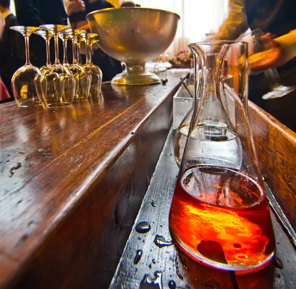 Bar table with bottle of alcoholic liquor