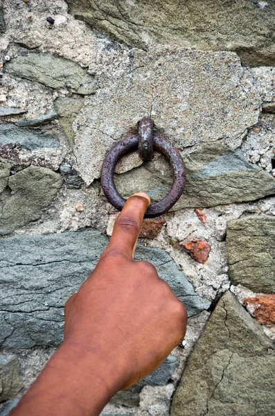 finger pulls an old rusty iron ring