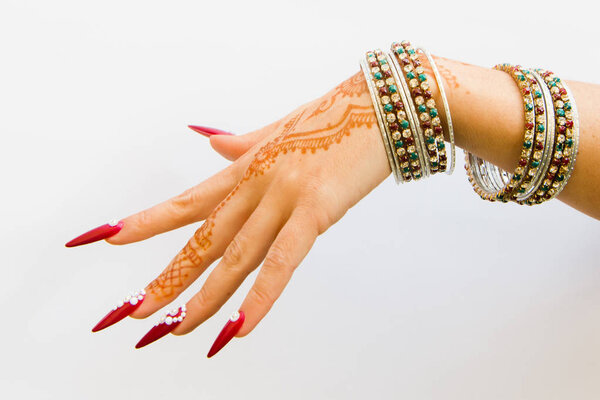 nails decorated with brilliant and hand with henna tattoos