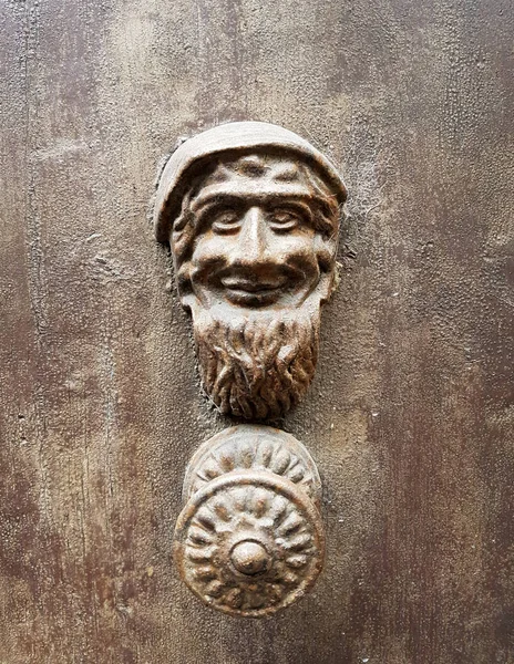 Старая дверь с ручками, сделанными маленьким гномом — стоковое фото