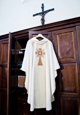 in the sacristy the cassock ready for Holy Mass clipart