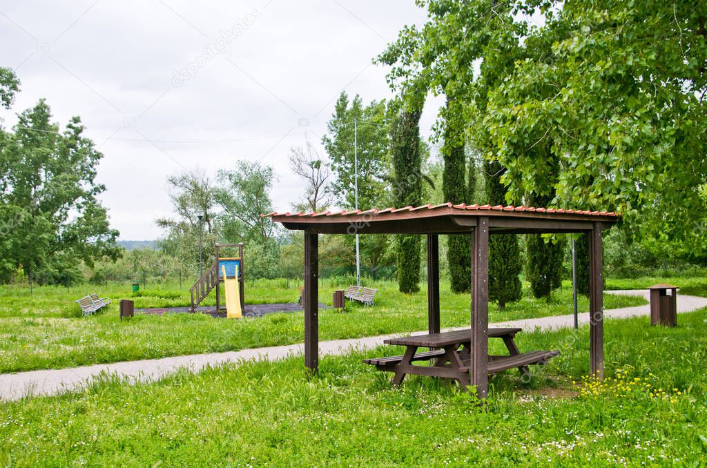 picnic area and children's games in the park amid the tall grass