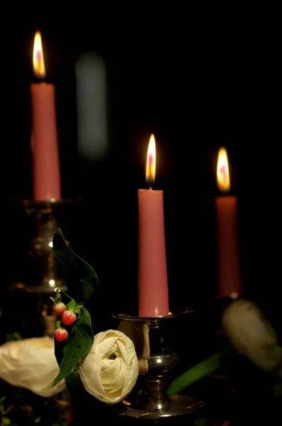 Candles shine in the dark and illuminate the roses given by your — Stock Photo, Image