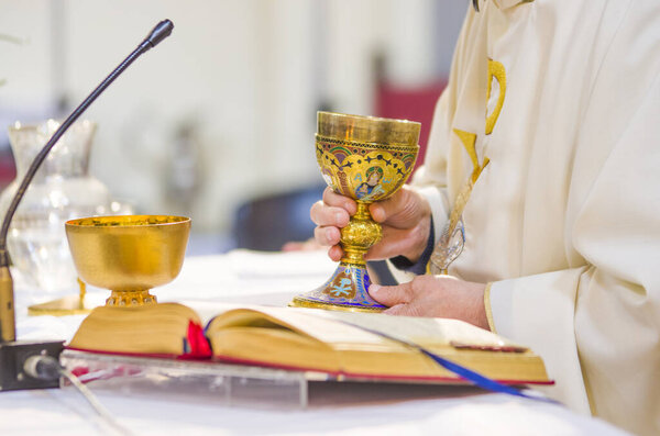 chalice with wine, consecrated in the blood of the risen Christ, ready for the communion of the faithful during mass