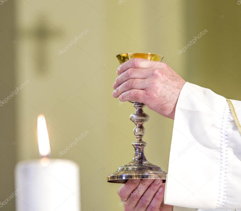 chalice with wine, consecrated in the blood of the risen Christ, ready for the communion of the faithful during mass