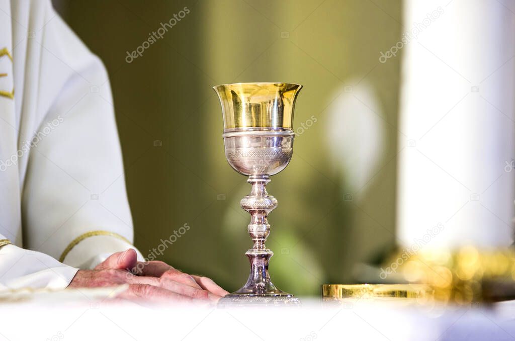chalice with wine, consecrated in the blood of the risen Christ, ready for the communion of the faithful during mass