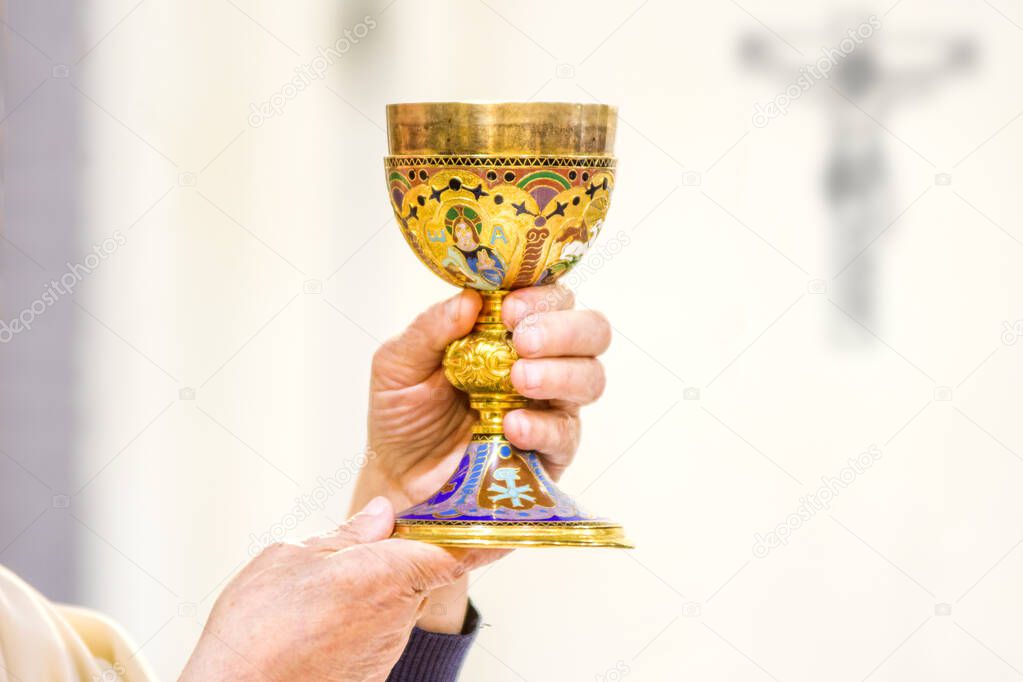 chalice with wine, consecrated in the blood of the risen Christ, ready for the communion of the faithful during mass