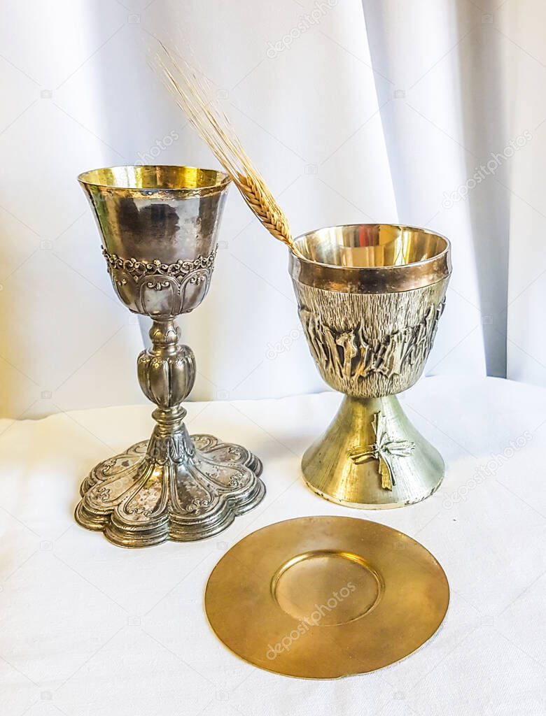 ear of wheat ripens for bread which becomes the body of jesus christ and chalice to receive wine, the blood of christ, for the mass of the faithful.