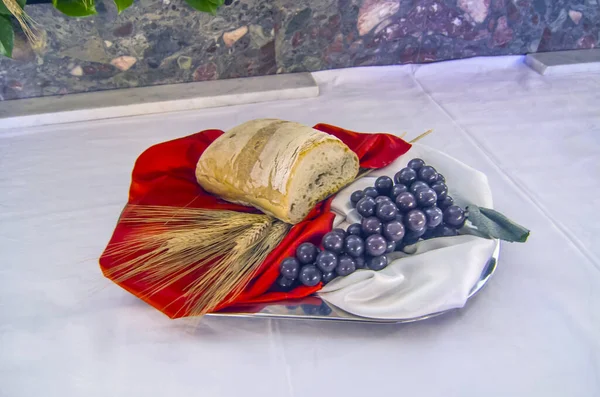 church altar with bread and grapes to become the body and blood of jesus christ during the holy mass