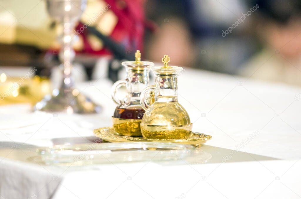church altar with small wine vial ready to become the blood of jesus christ during the mass