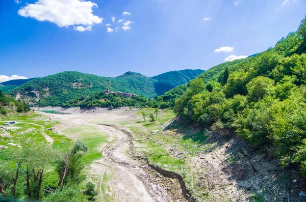 environmental catastrophe, drought drama and rising temperature of the planet earth, dry river, dry vegetation and population of the mountain town without water.