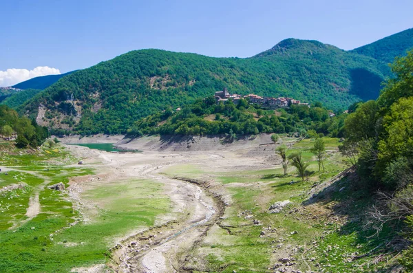 environmental catastrophe, drought drama and rising temperature of the planet earth, dry river, dry vegetation and population of the mountain town without water.