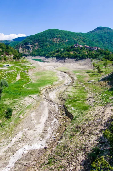 environmental catastrophe, drought drama and rising temperature of the planet earth, dry river, dry vegetation and population of the mountain town without water.