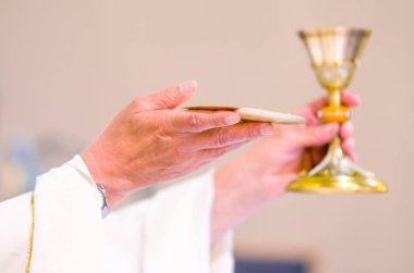 in the church wine becomes the blood of christ, and the host becomes the body of christ clipart