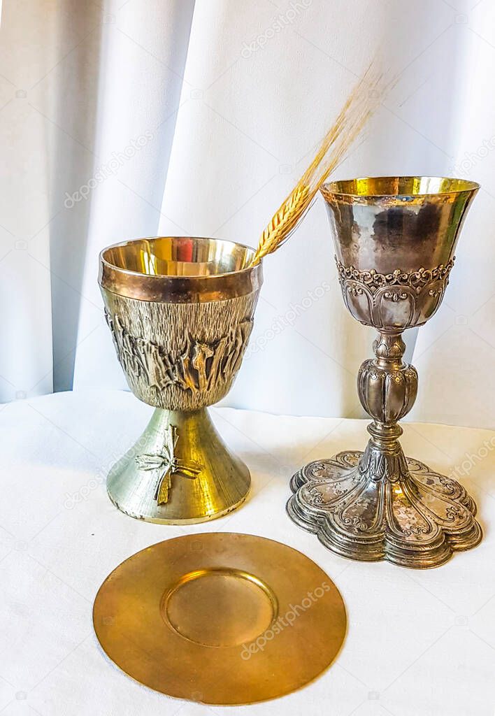 ear of wheat ripens for bread which becomes the body of jesus christ and chalice to receive wine, the blood of christ, for the mass of the faithful.