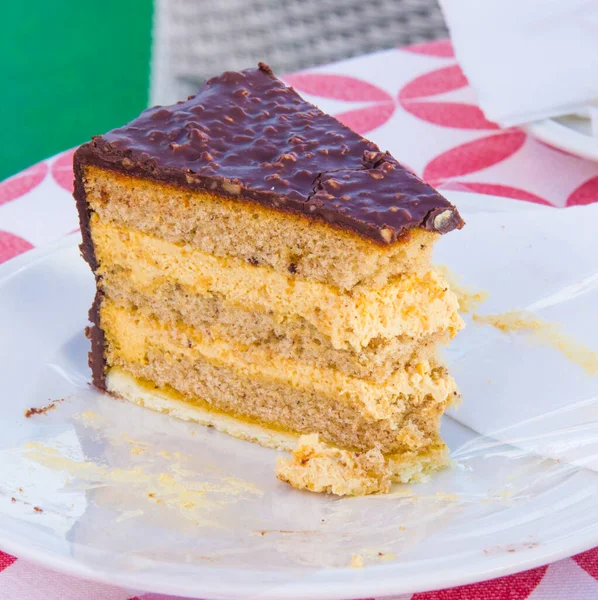 multilayer cake with chocolate, hazelnut and buckwheat covered with bitter cocoa and almonds
