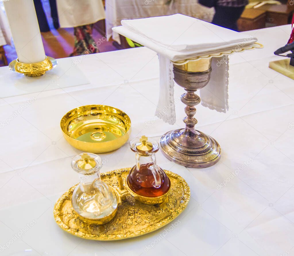 chalice for wine, blood of christ, and ciborium with host, body of christ, and ampoules with wine and water for the consecration on the others of the churches for pope francesco